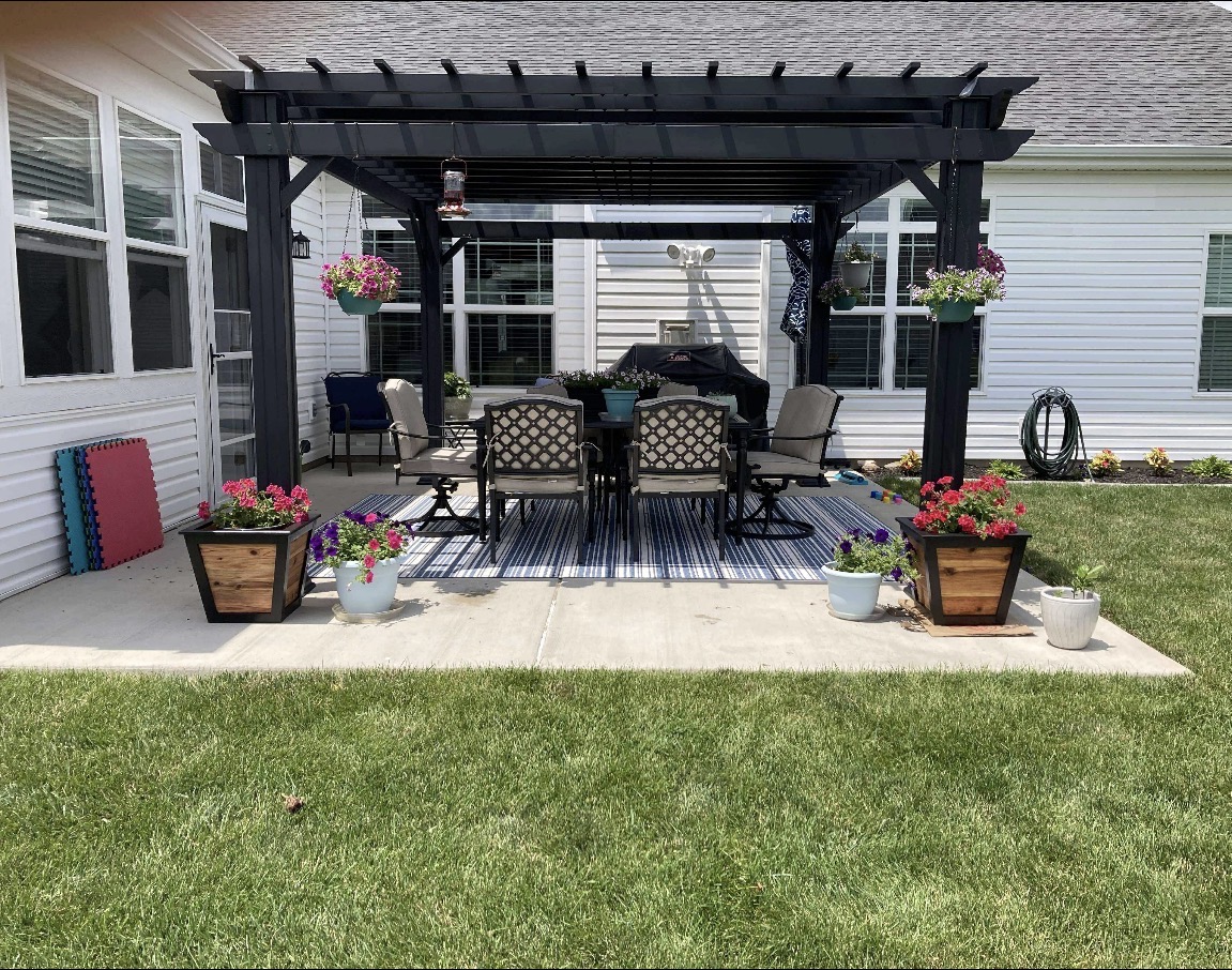 Pair of cedar planter boxes styled on a backyard patio