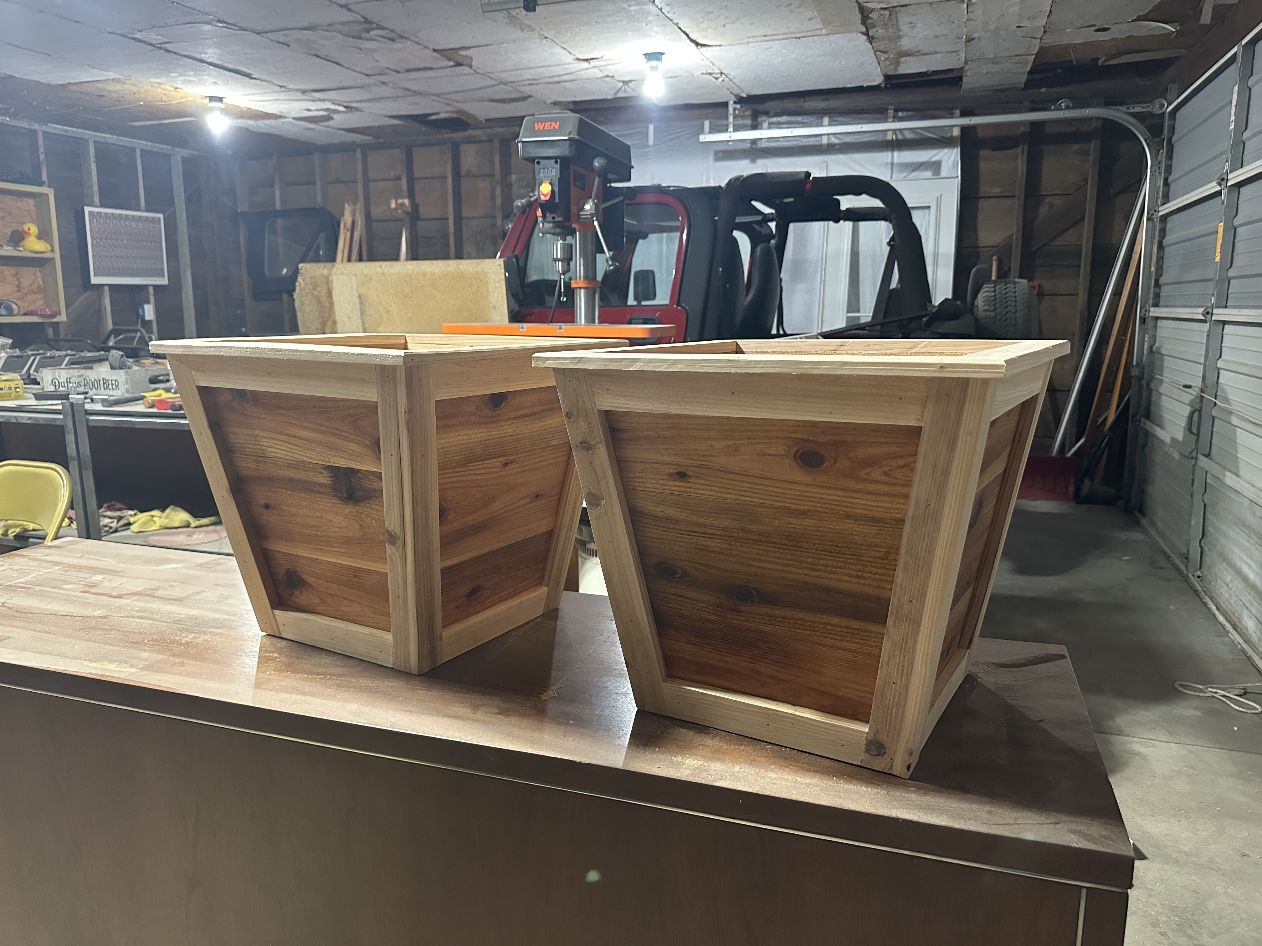Two cedar planter boxes side by side in workshop