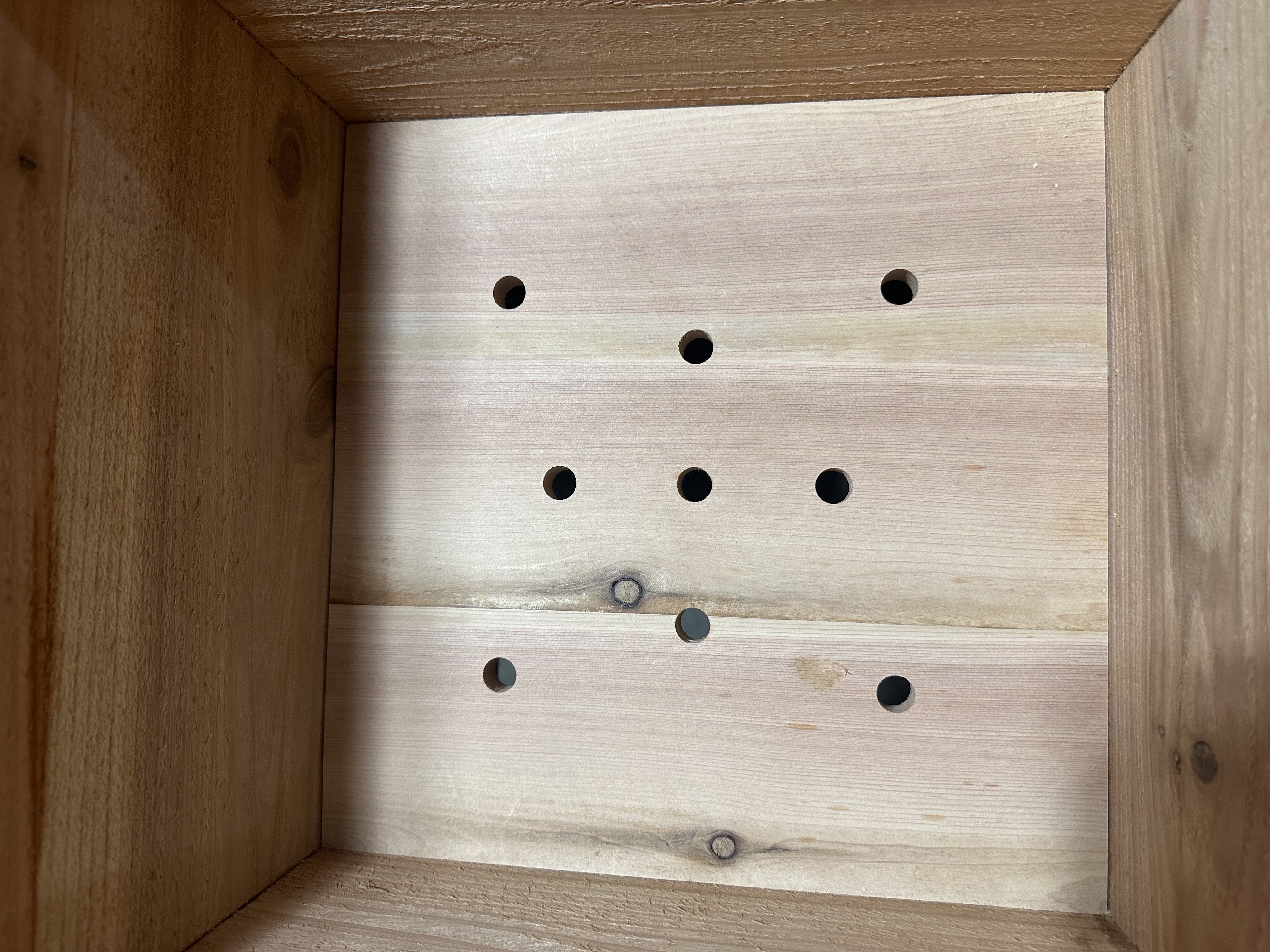Drainage hole detail inside cedar planter box